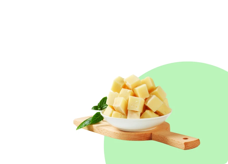 Diced cheese on a wooden board
